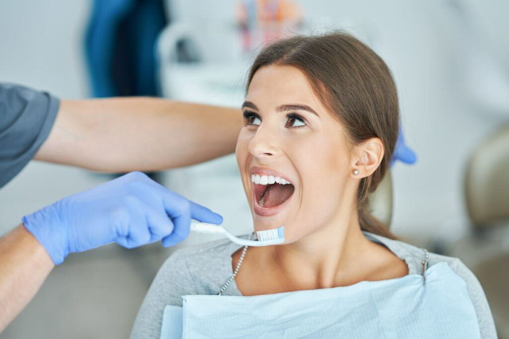 Male dentist and woman in dental clinic