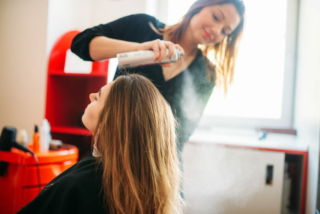 Stylist is preparing to apply mousse, female hairdress in hairdressing salon. Hairstyle making in beauty studio