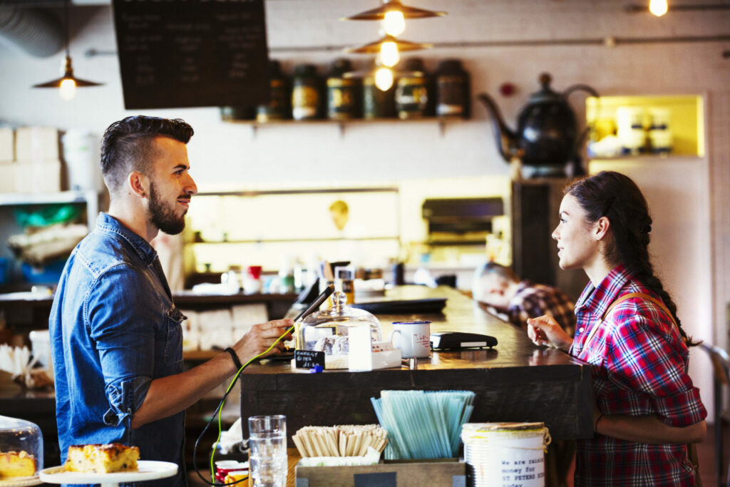 barista-and-customer-in-coffee-shop-2022-03-04-02-39-46-utc-scaled-1.jpg